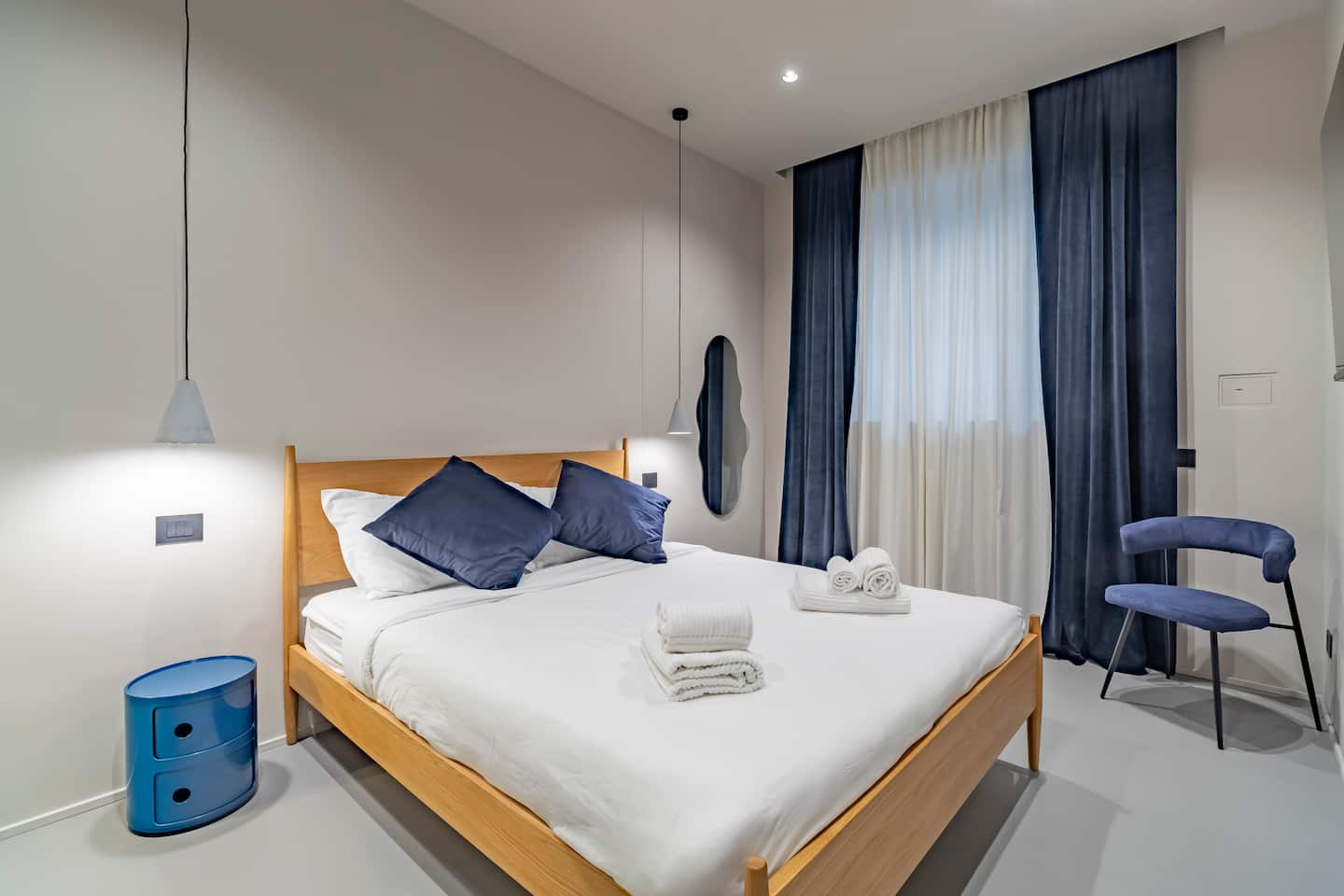 Double bedroom with wooden headboard and blue accents