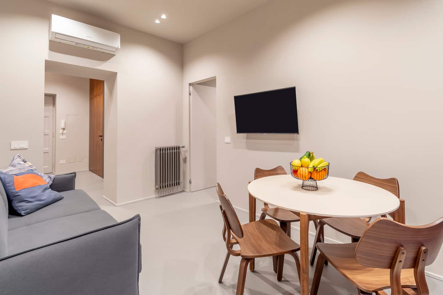 Living room with sofa, dining area and Smart TV